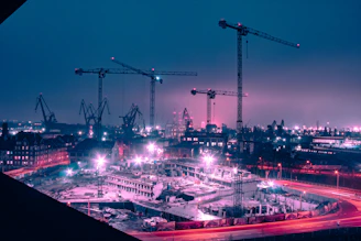 Bright LED lighting systems illuminating a modern construction site at dusk.