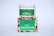 A white container with a green label for 'Carnation Organic Aloe Vera Gel' is placed on top of a colorful box featuring images of various fruits and flowers.