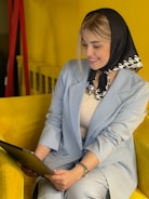 A smiling businesswoman presenting a digital growth plan on a tablet.