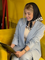 A smiling therapist using a tablet to manage appointments with the Profissio platform.
