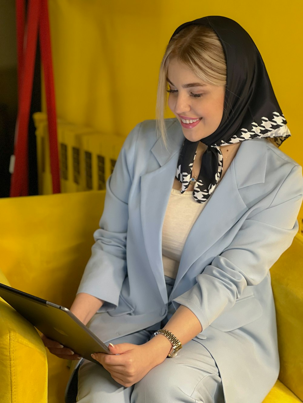 a woman sitting on a yellow couch