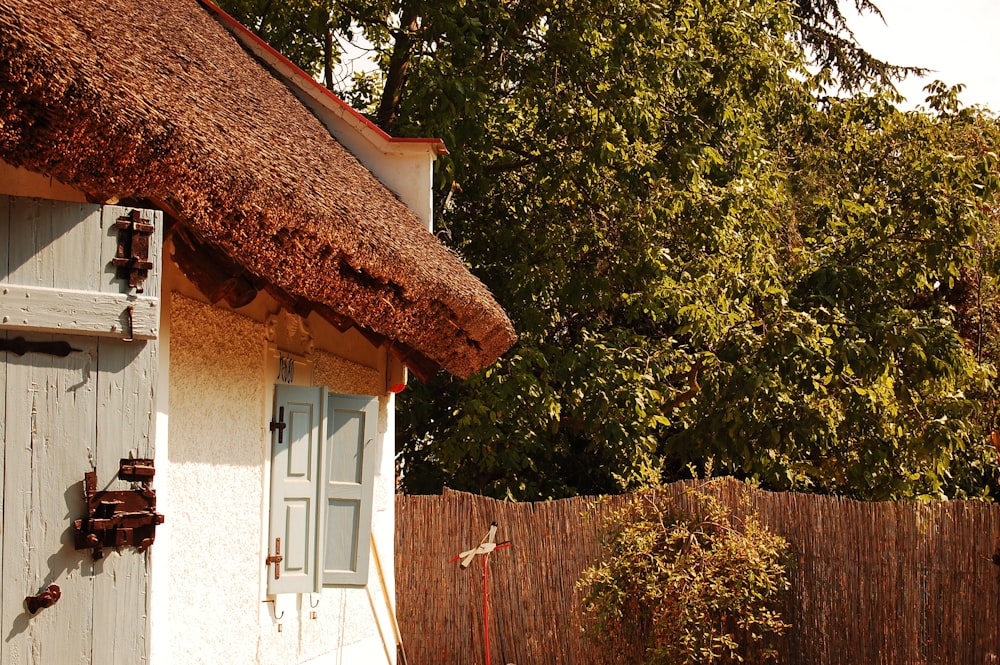 a house with a fence and trees in the back