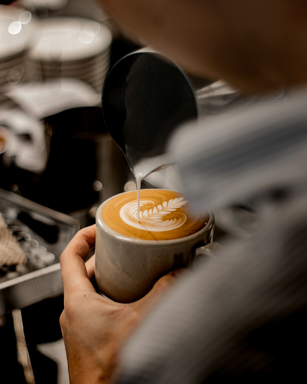 a hand holding a cup of coffee