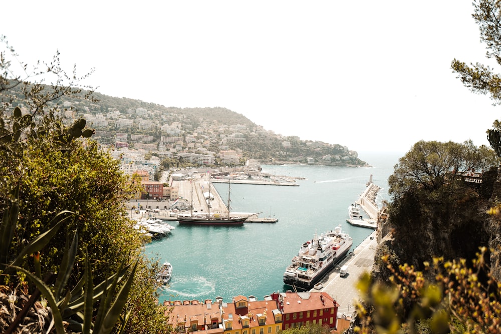 a body of water with boats in it and a hill in the back