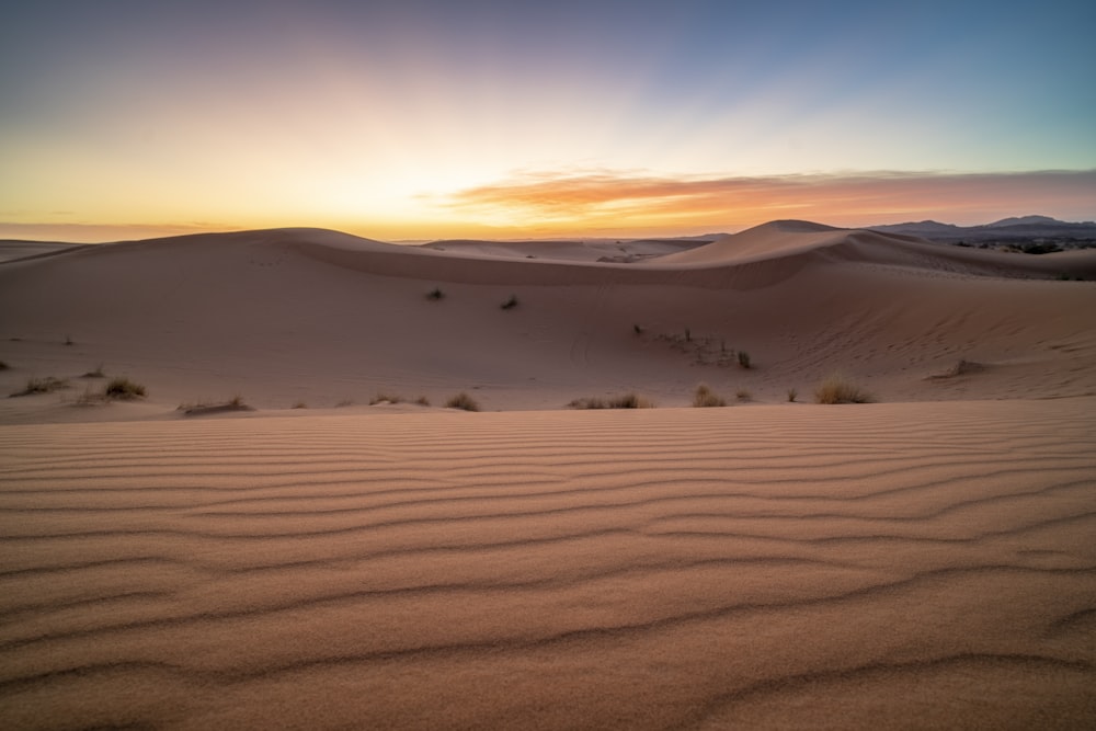 a desert landscape with sand dunes