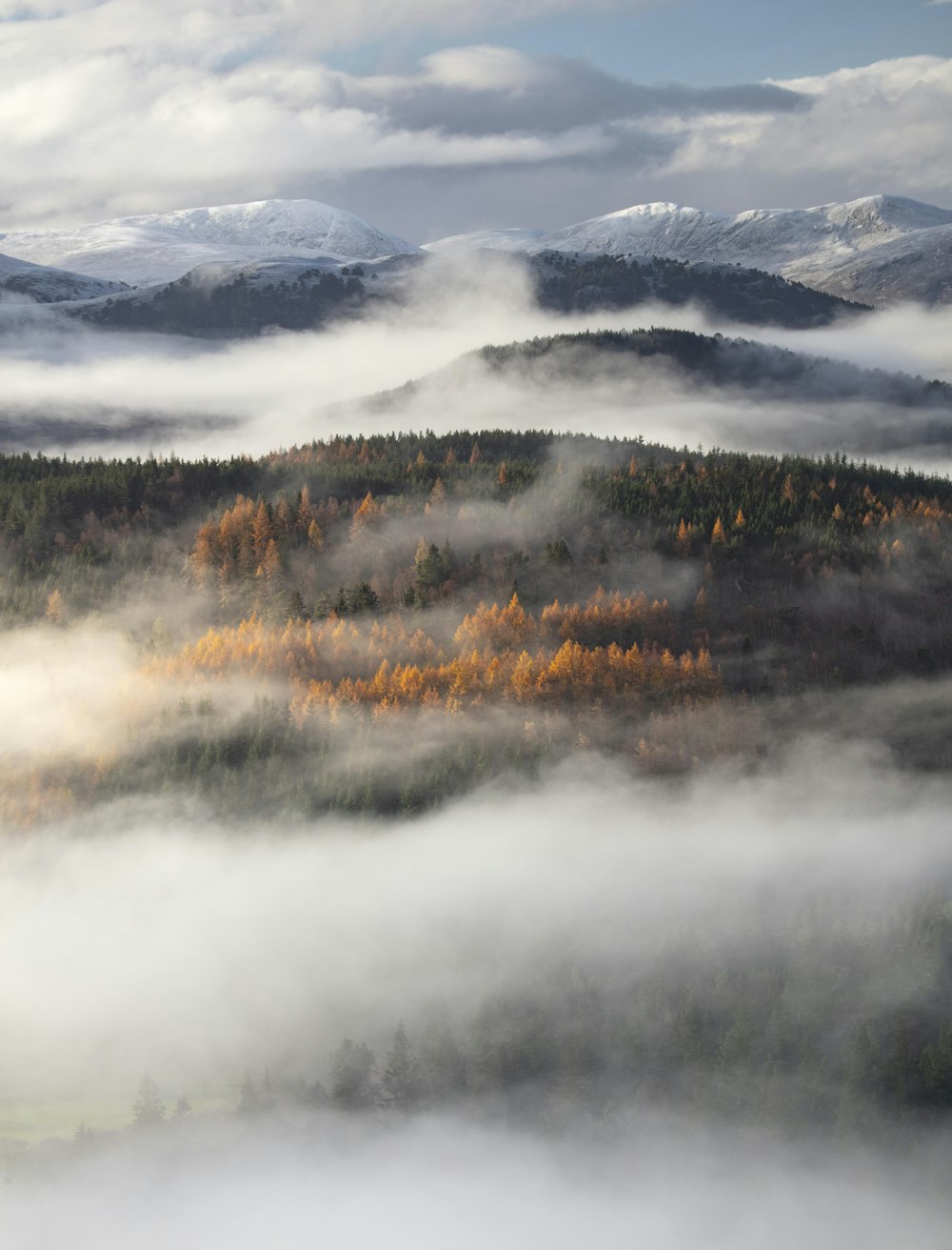 a mountain range with clouds