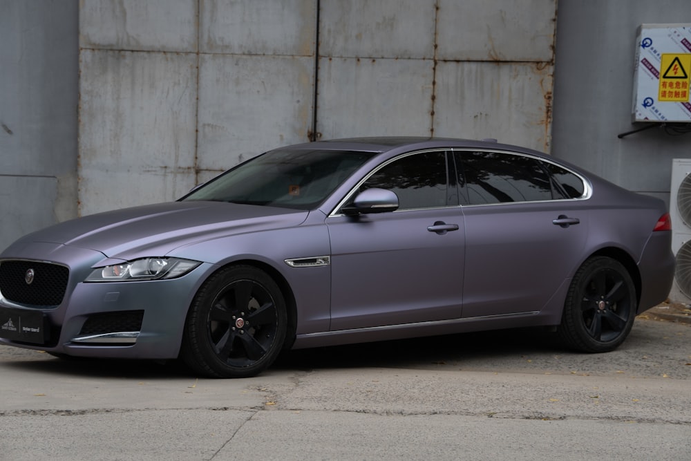 a silver car parked in front of a building