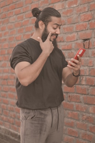a person holding a red phone