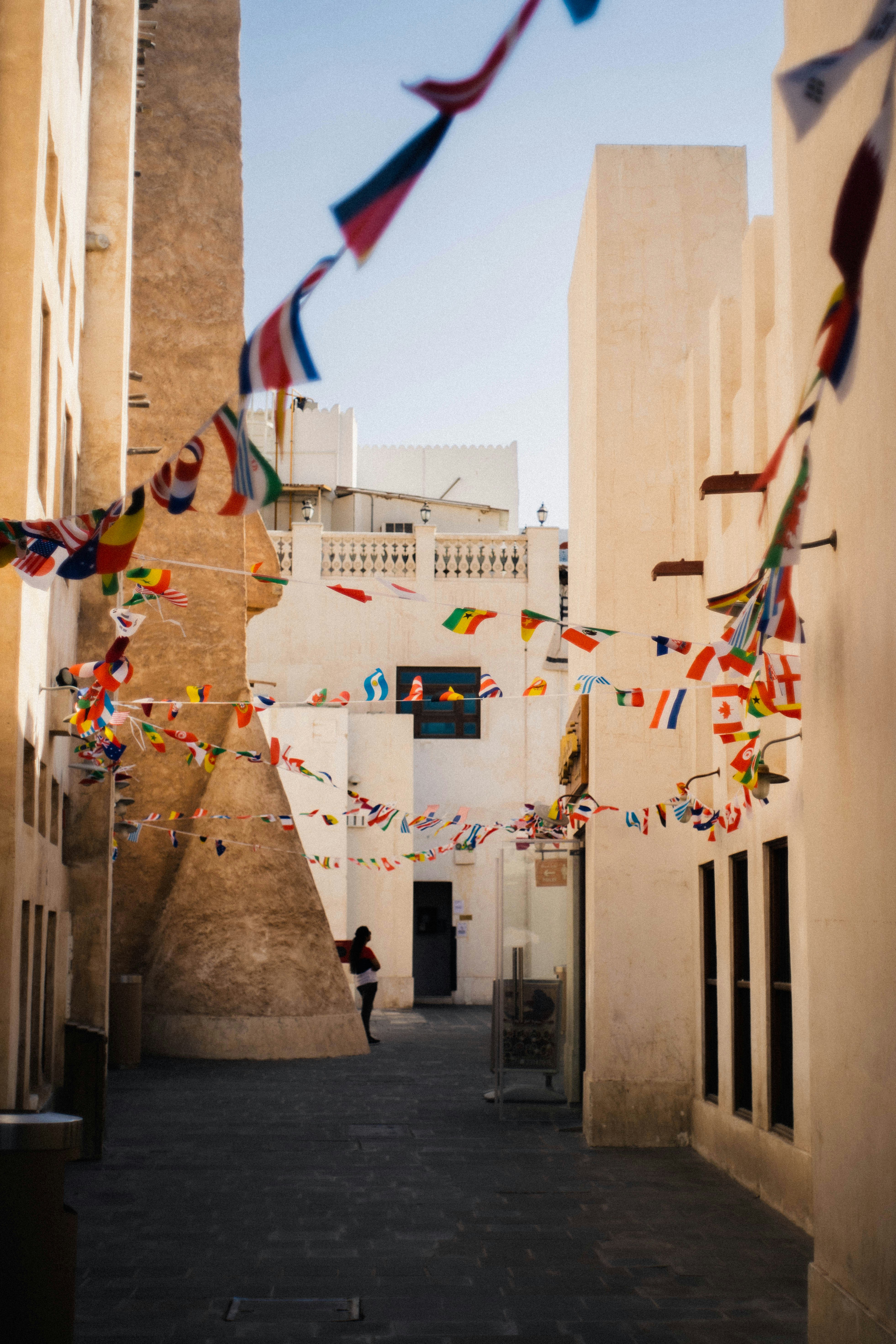 a street with flags from the buildings