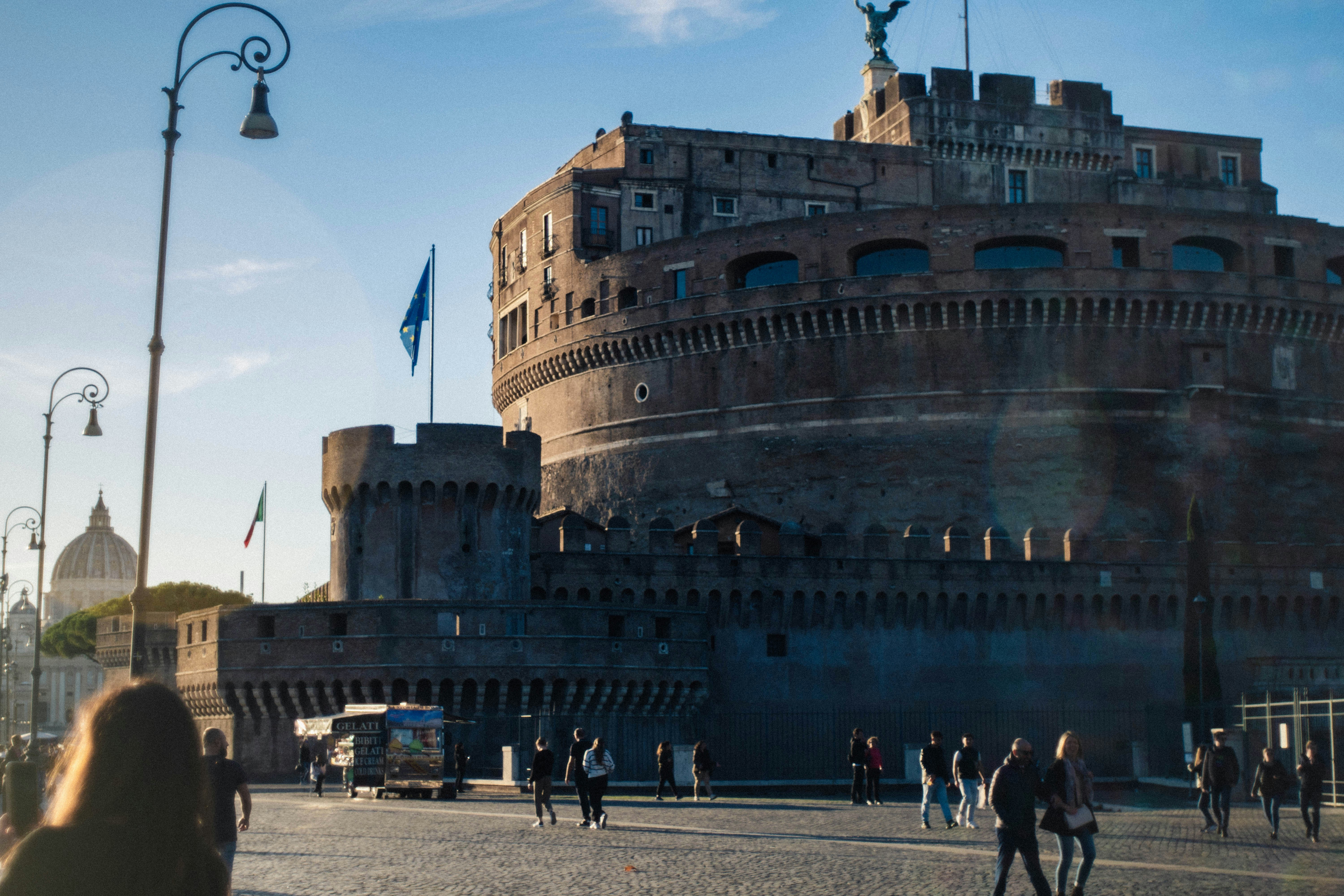 a group of people walking in front of a large building