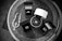 Various pieces of jewelry including rings and a necklace are displayed in open boxes on a textured surface. The arrangement is symmetric and the items appear to be of high value.