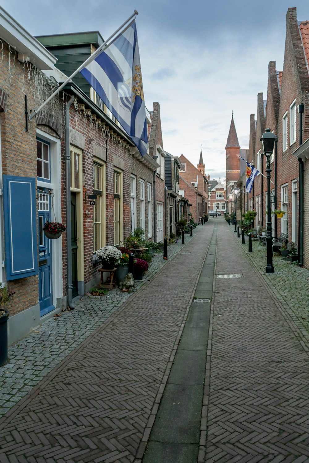 a brick road with buildings on either side of it