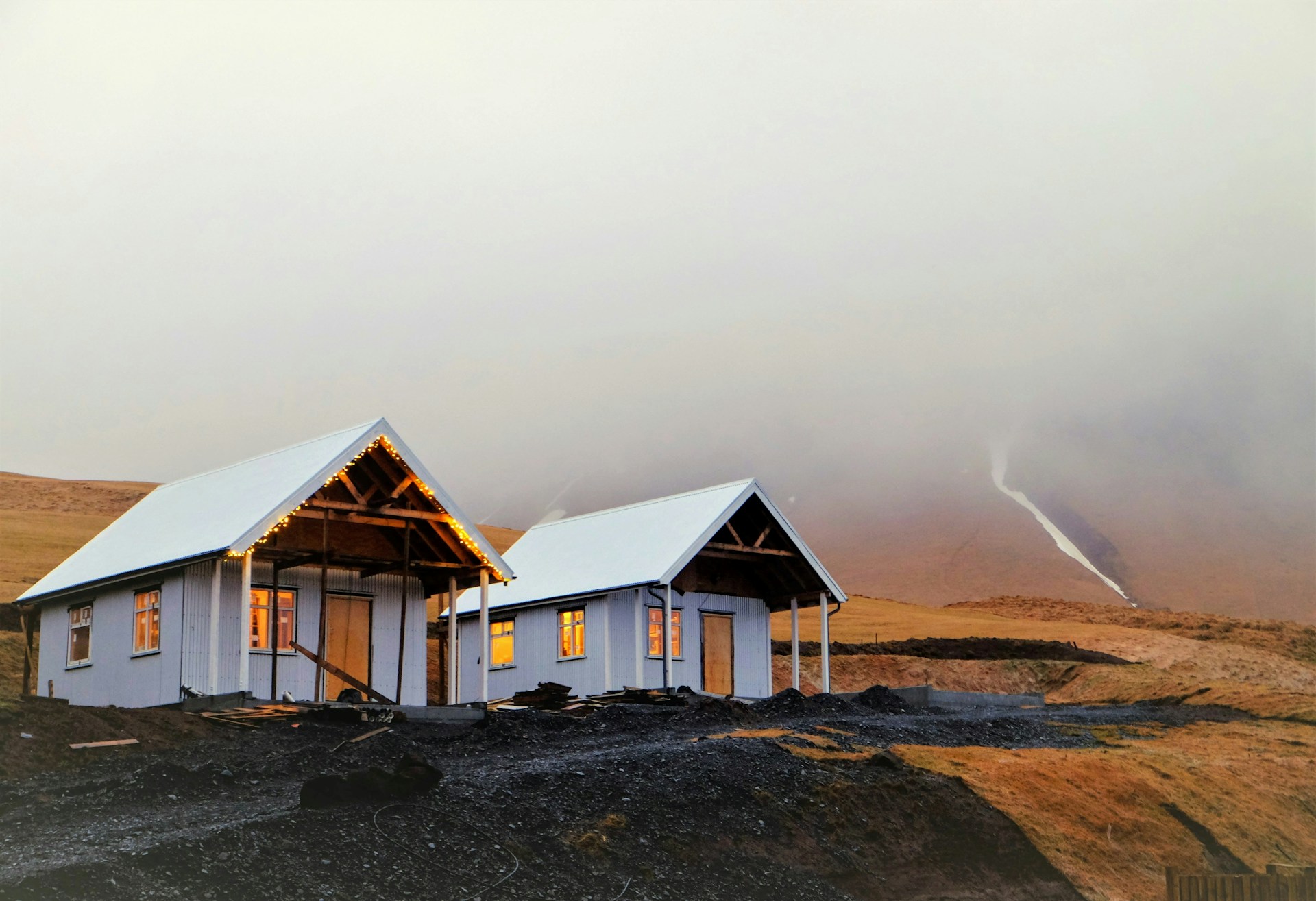a couple of houses on a beach