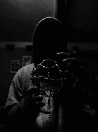 A mysterious, shadowy figure narrating a story to attentive players in a cozy, darkened room.