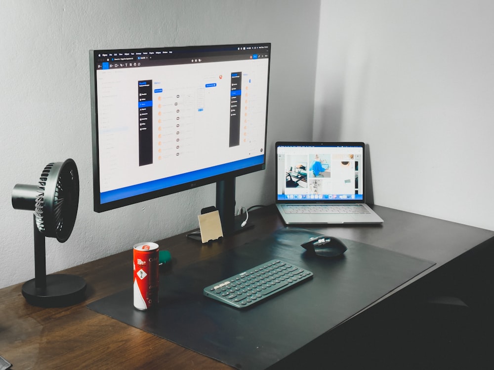 a laptop and a desktop computer on a desk