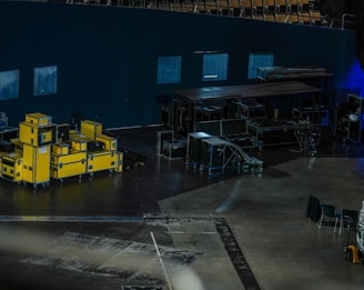 a large room with yellow machines