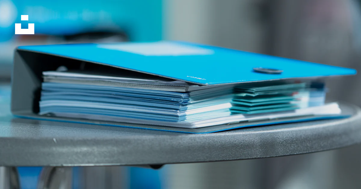 A stack of files photo – Free Blue Image on Unsplash
