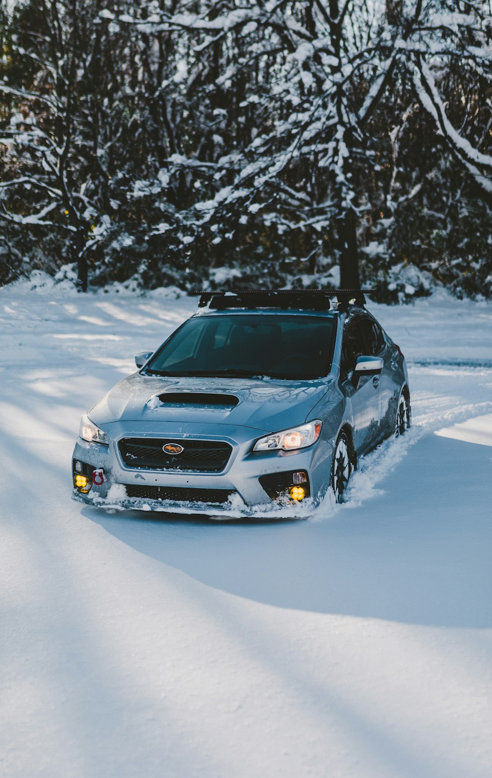 a blue car parked in the snow