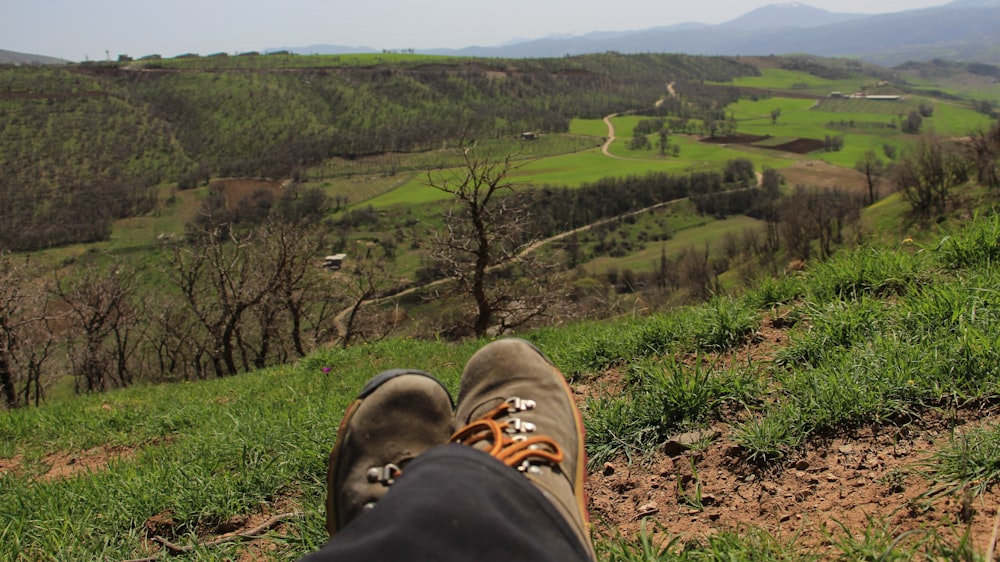 a person with their feet up on a hill