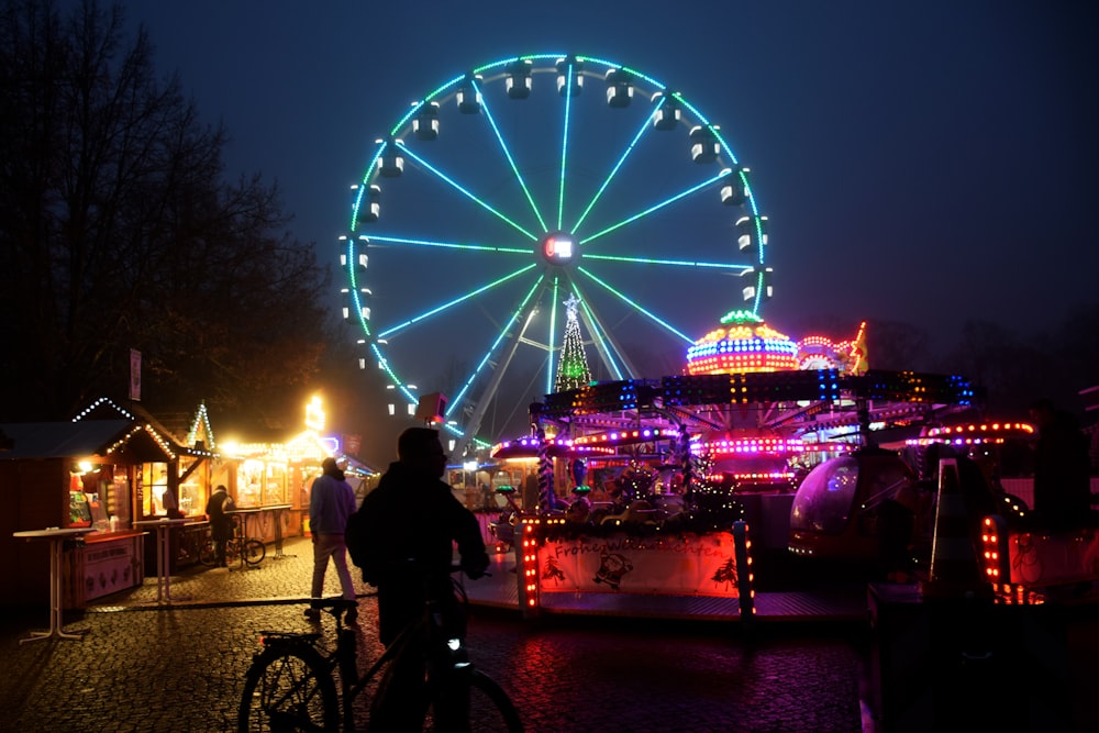 a ferris wheel lit up at night