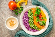 Colorful salad bowl with fresh greens, tomatoes, and homemade dressing.