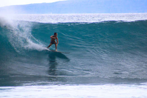 a man surfing on a wave