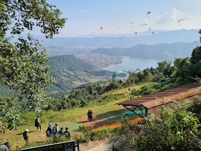 A scenic view of the fly park with paramotors in the sky.