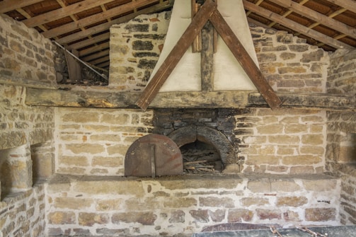 The original oak beams and inglenook fireplace inside the cottage.