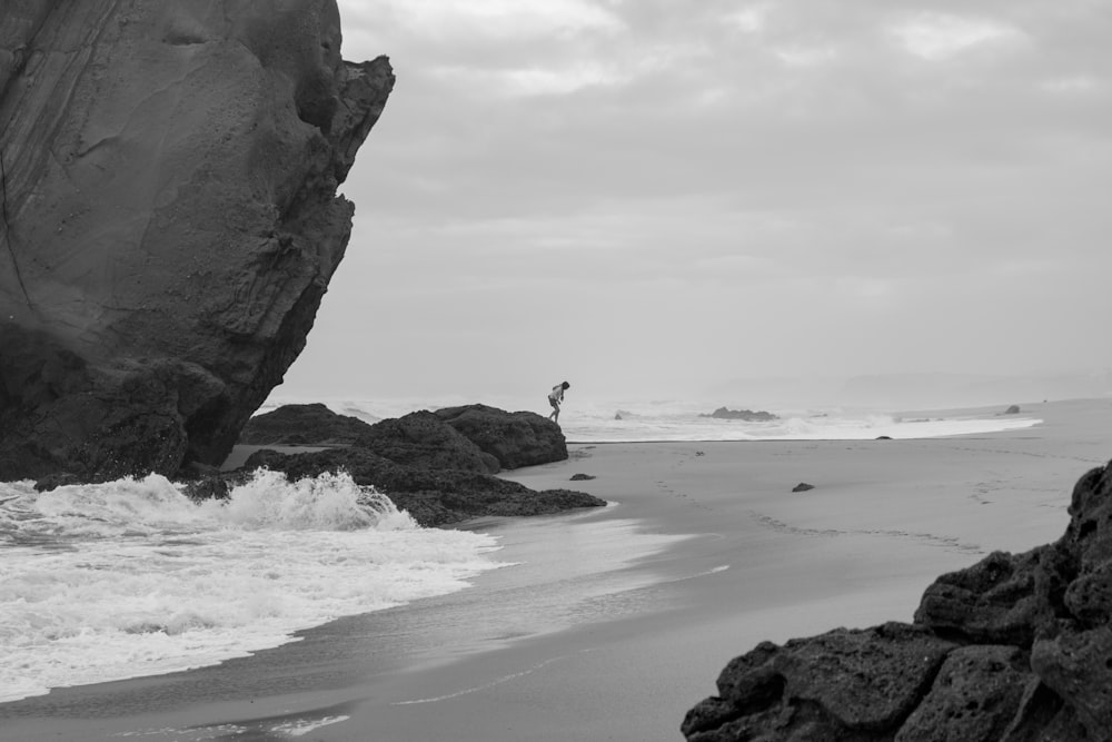 a person standing on a rock in the water