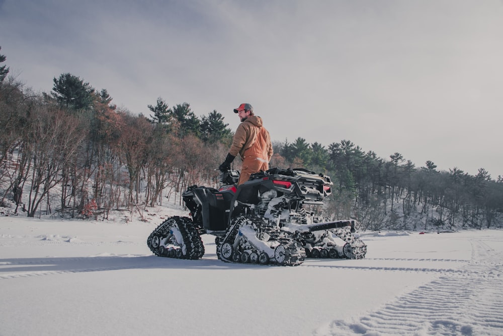 a man standing on a snowmobile