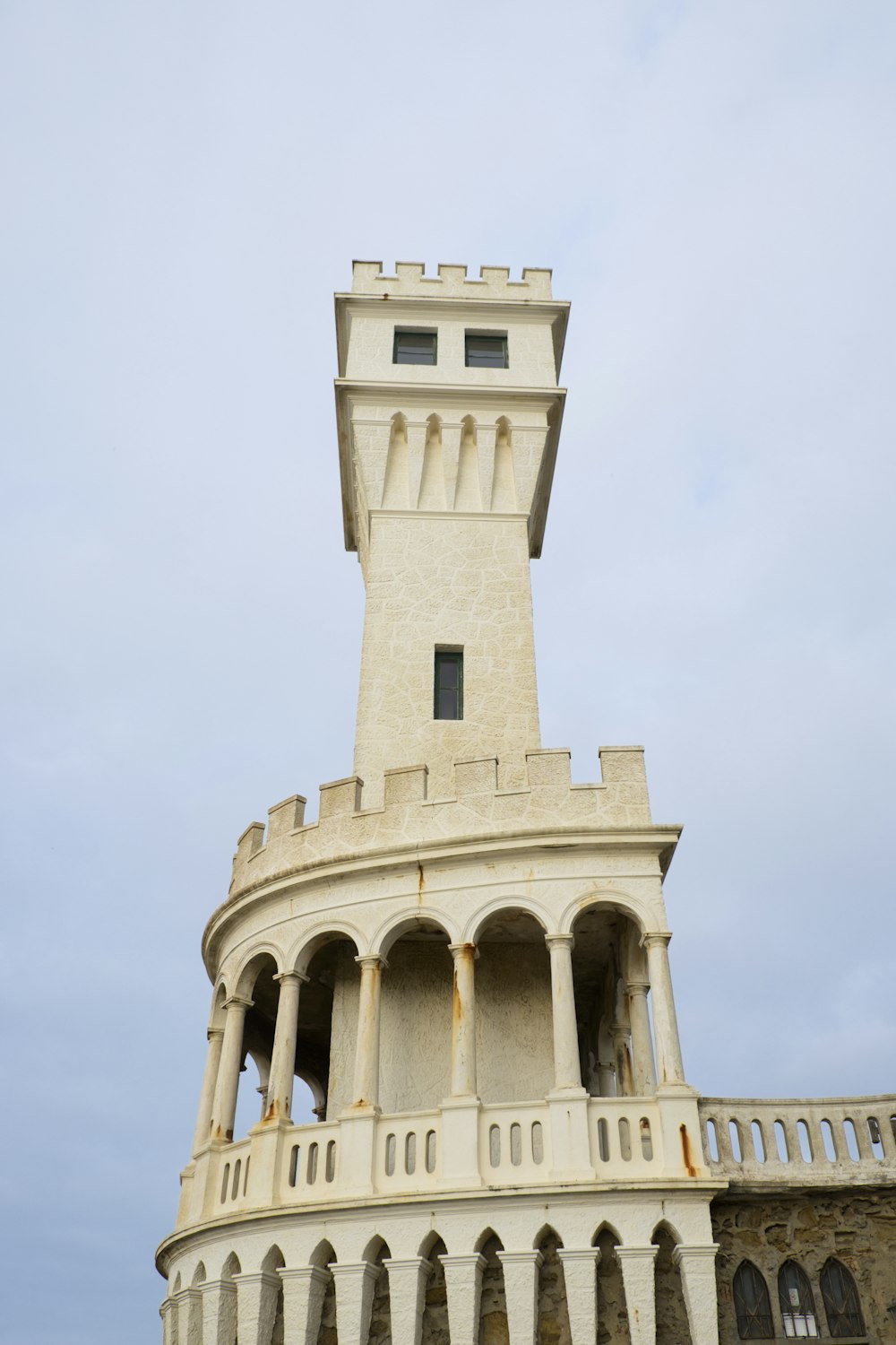 a tall white building with a tower