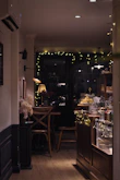 Warm, inviting interior of nine7seven café with soft lighting and elegant coffee setup.