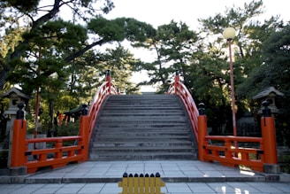 a set of stairs leading up to a red gate