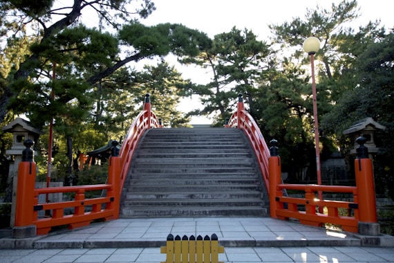 a set of stairs leading up to a red gate