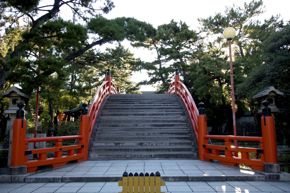 a set of stairs leading up to a red gate