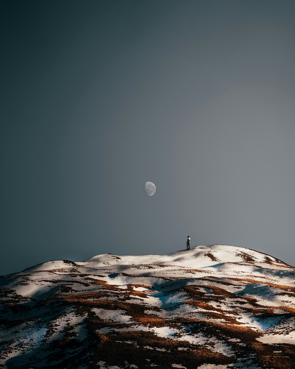 a person standing on a snowy mountain