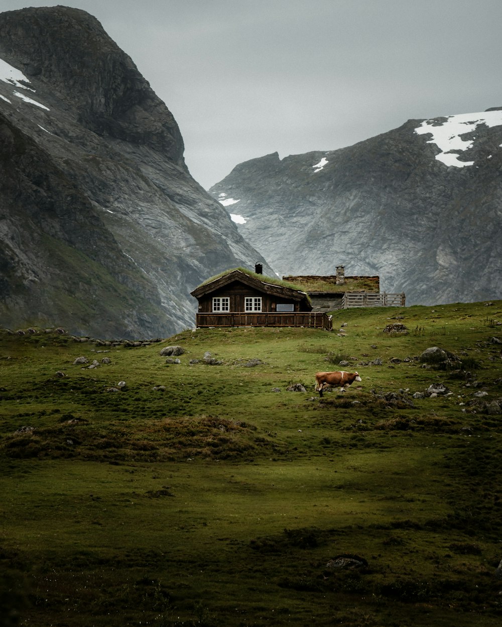 a house in a valley between mountains