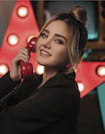 a woman holding a red telephone