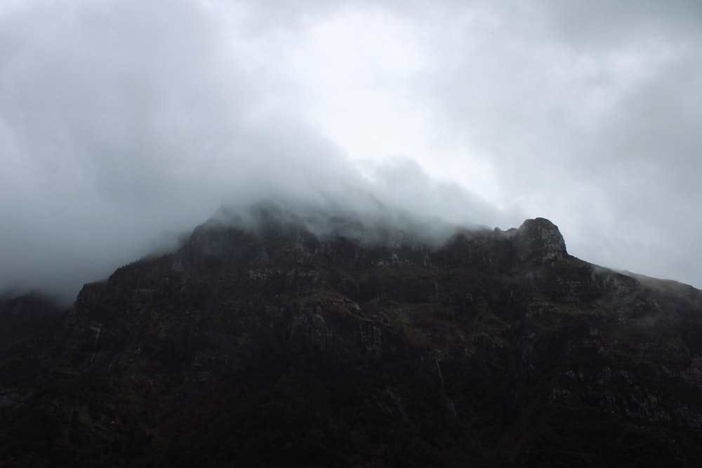 a very tall mountain with a very cloudy sky