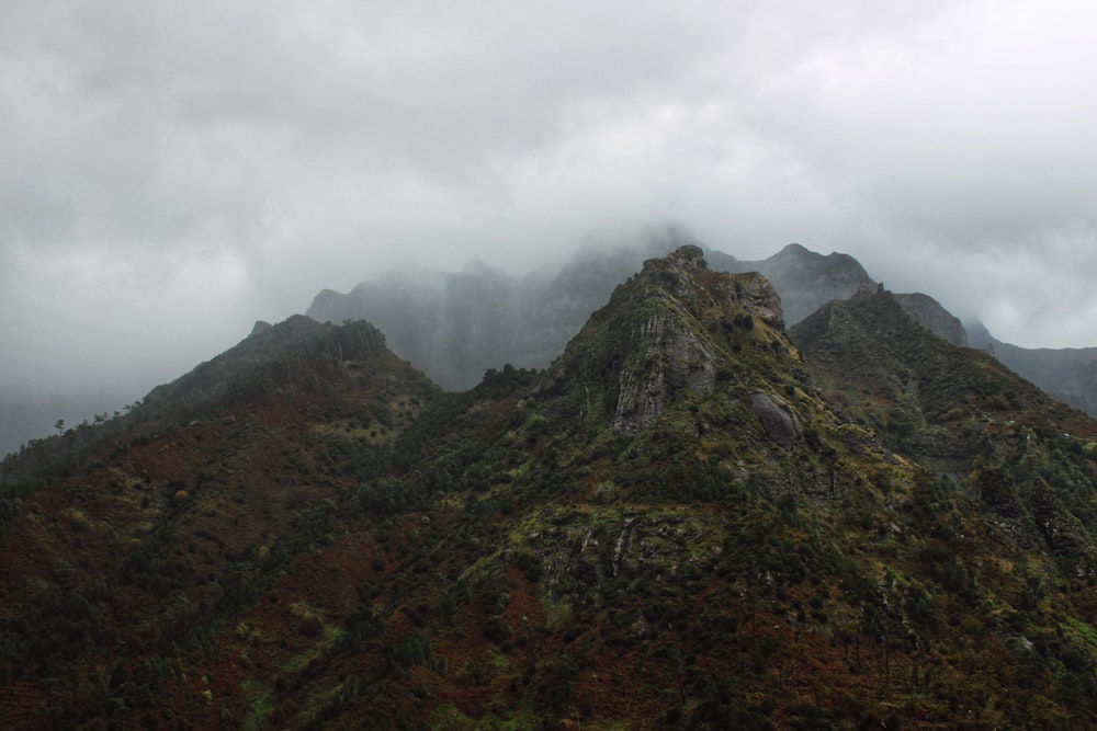 a mountain with clouds above