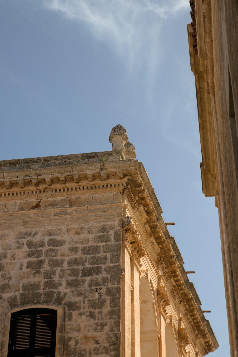 a stone building with a statue on top