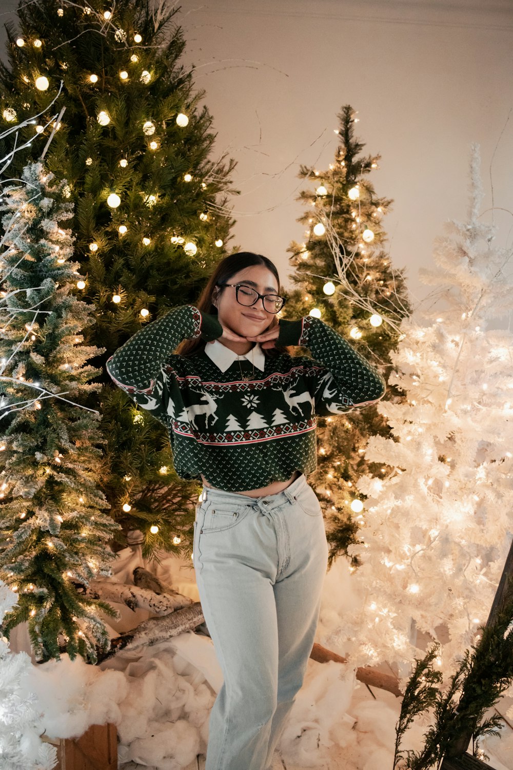 a person standing next to a christmas tree