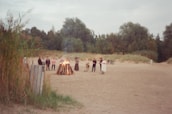 Happy bikers sharing stories around a campfire after a long day of riding through Moroccan landscapes.