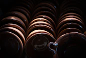 Brightly glazed bowls stacked neatly, catching natural light by a window.