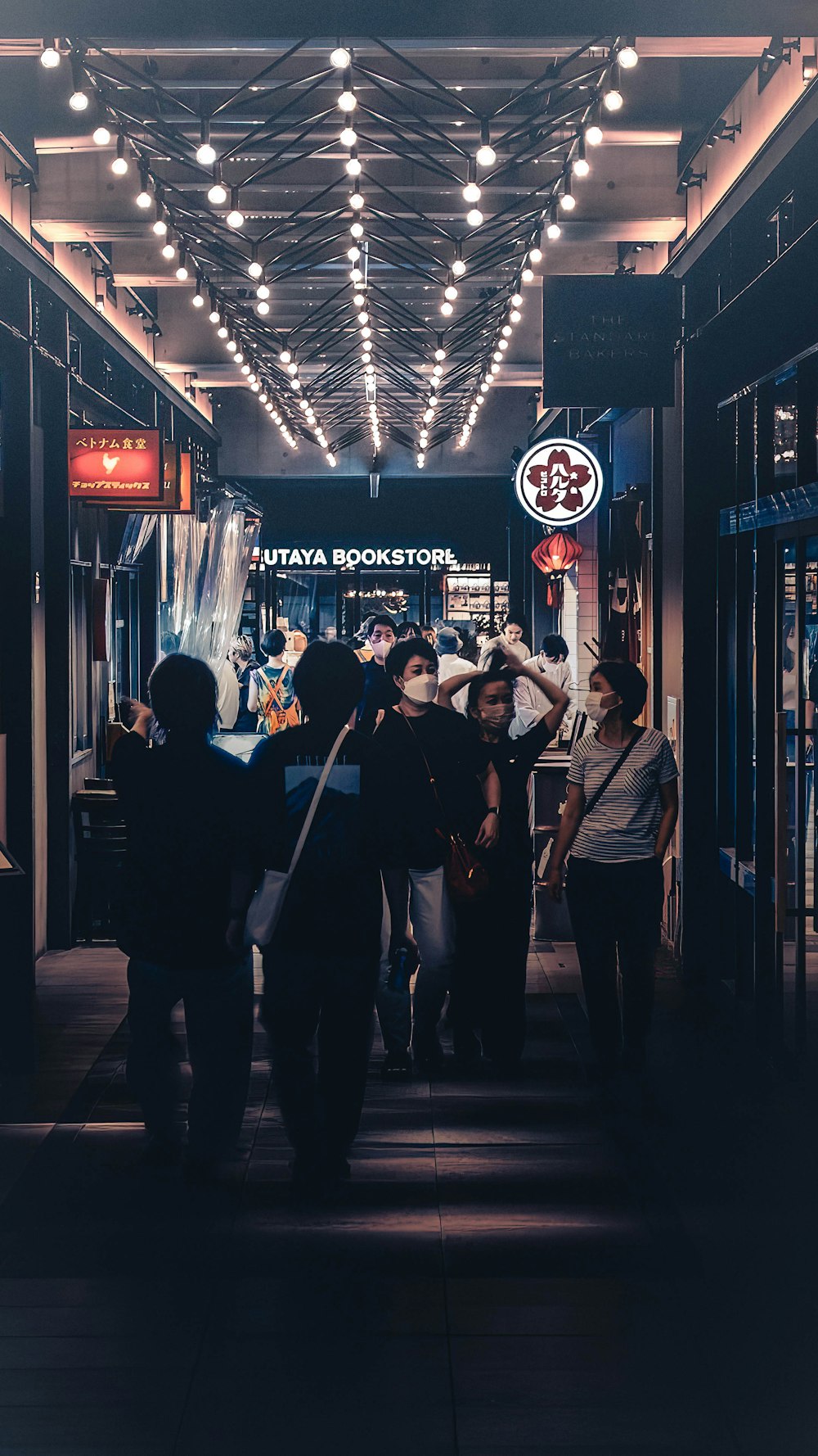 a group of people standing in a hallway