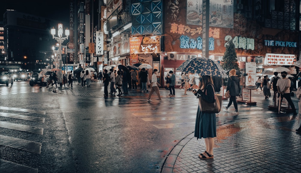 a woman holding an umbrella on a busy street