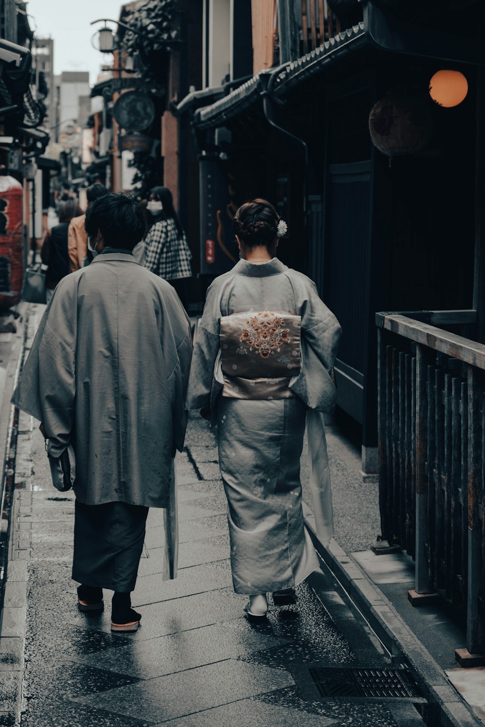 a group of people walking down a sidewalk