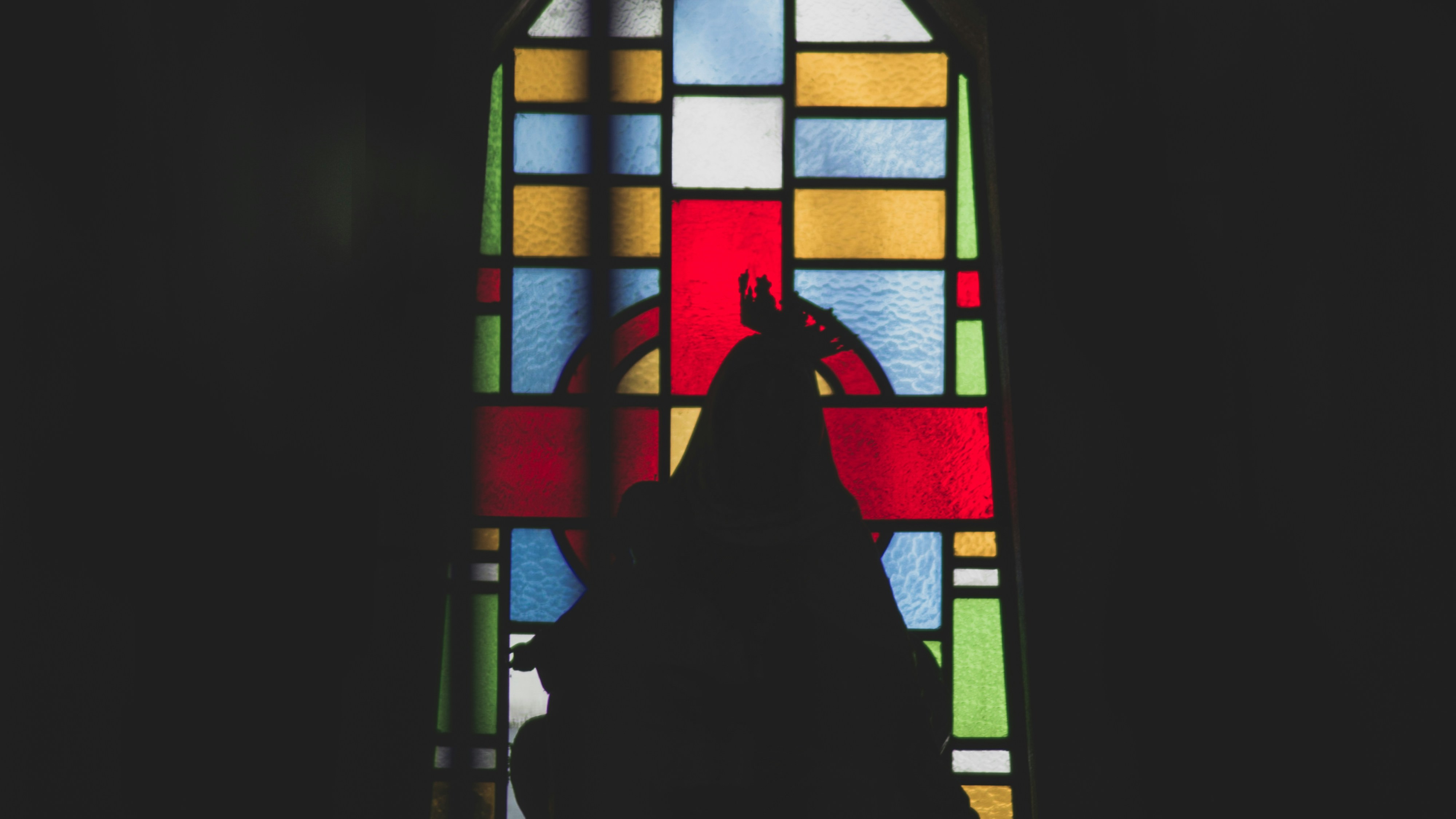 a person sitting in a chair in front of a window