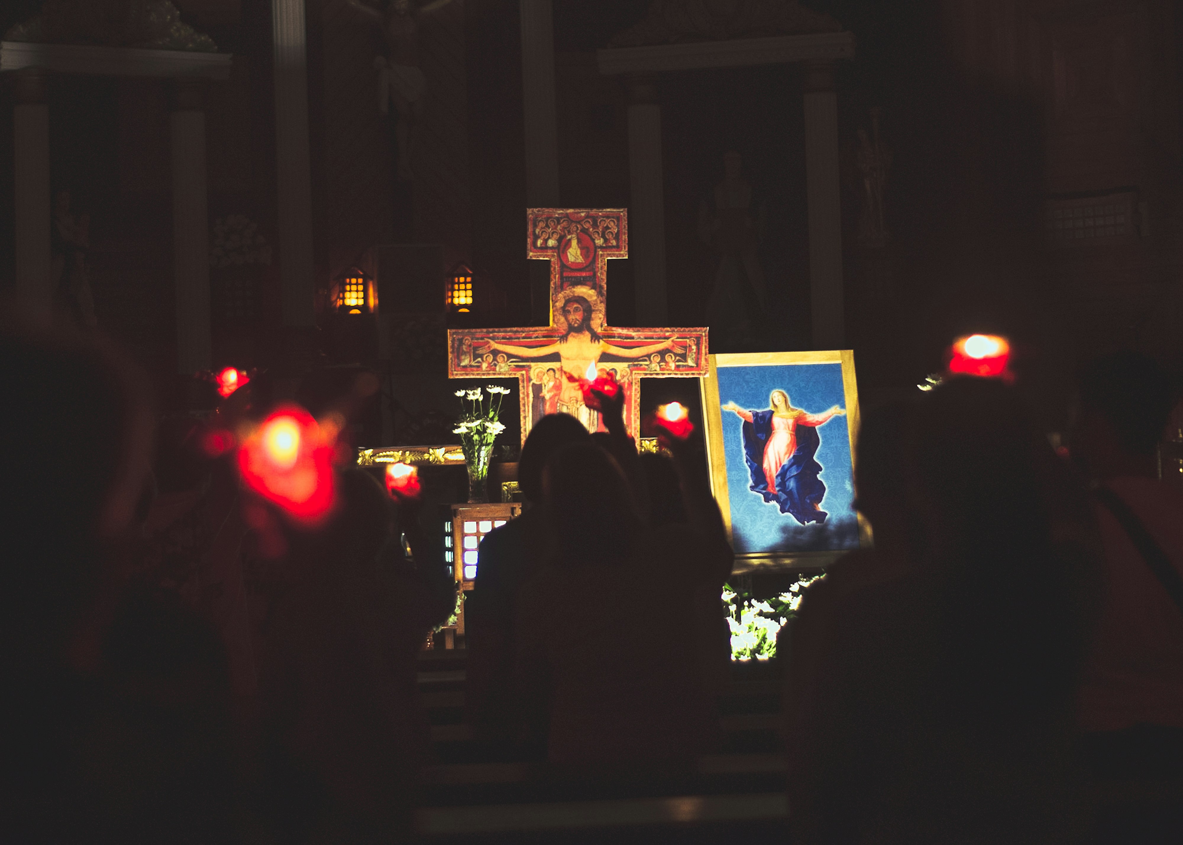 a group of people in a dark room with a television screen