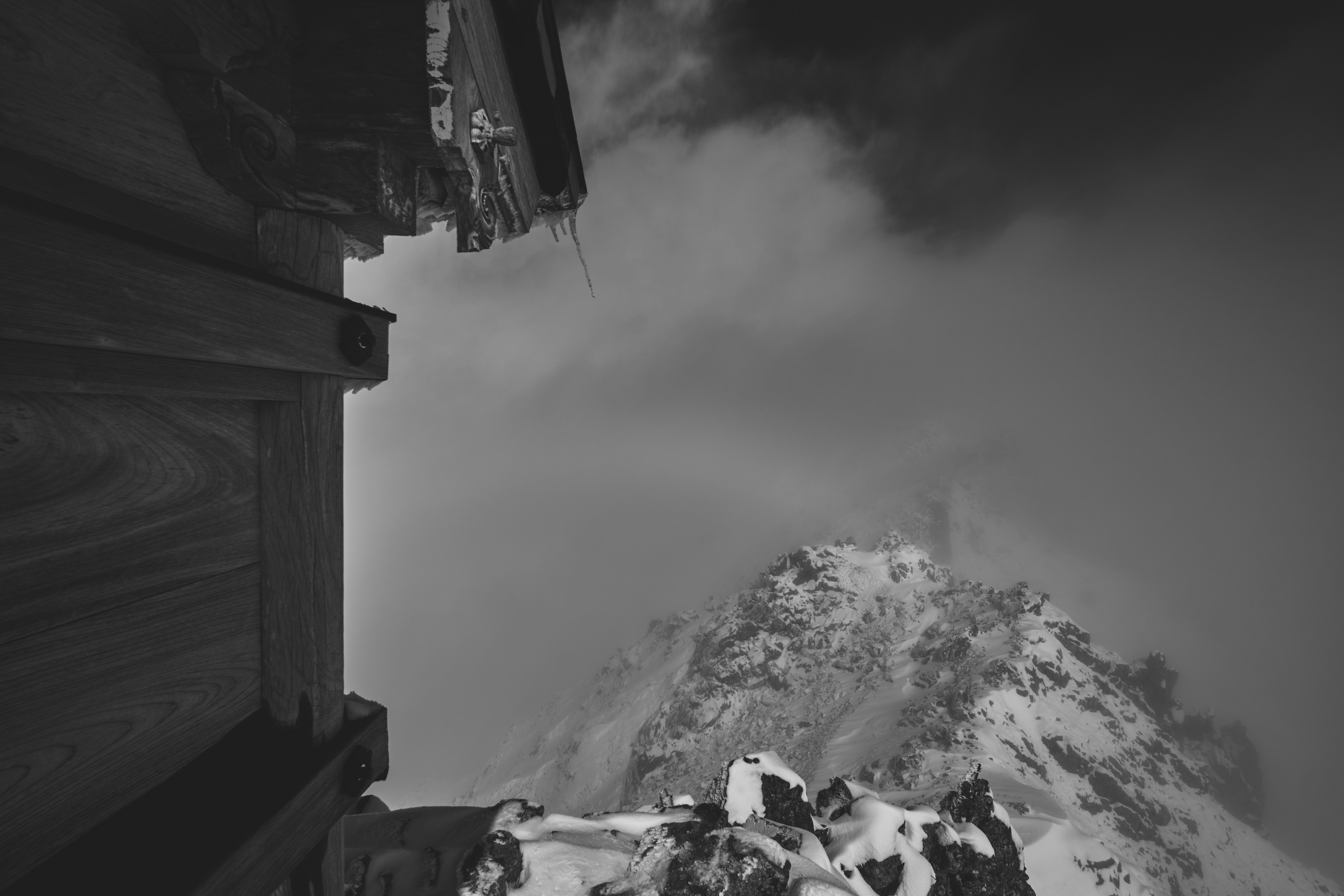 a snowy mountain with a building